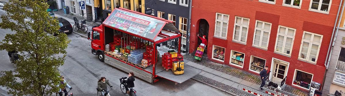 Distributionsbil læsser kasser med øl og sodavand af på Gammel Mønt i indre København